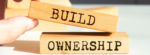 hand building blocks that say Build Ownership